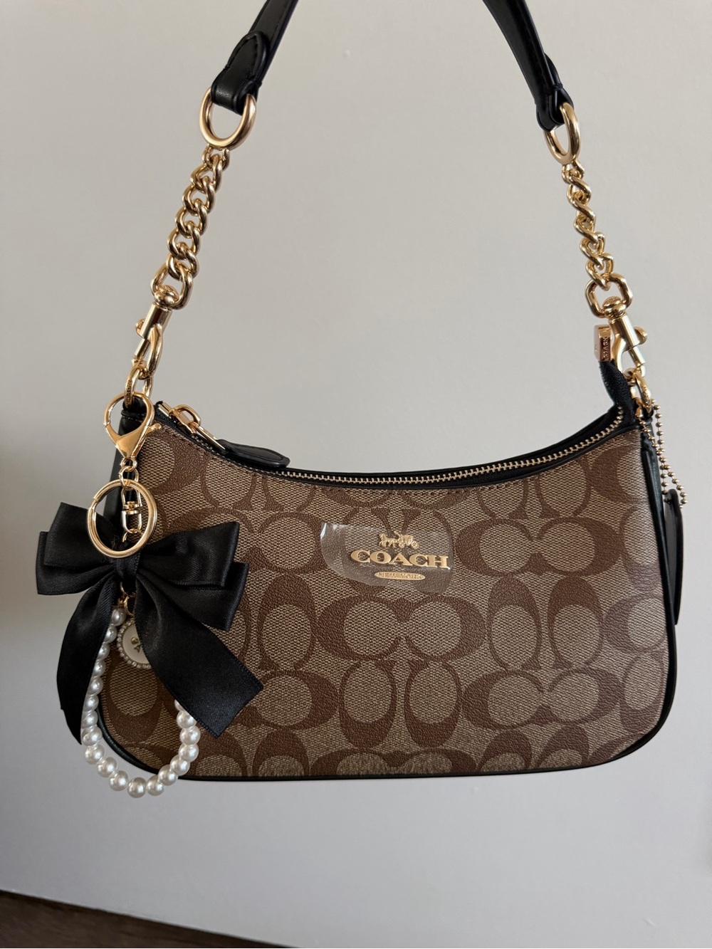 Coach Brown Signature Canvas Shoulder Bag with Black Bow and Gold Hardware
